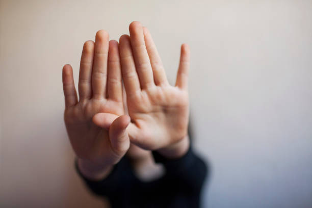 istock Little girl protects herself with her hand 1145629214