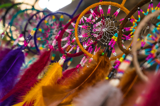 Colorful handmade dream catchers with feathers threads and beads hanging
