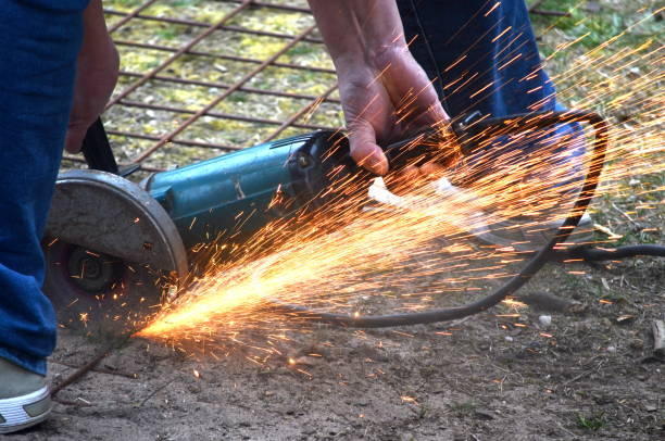 istock Handyman cuts concrete mesh with a grinding wheel 1145629824