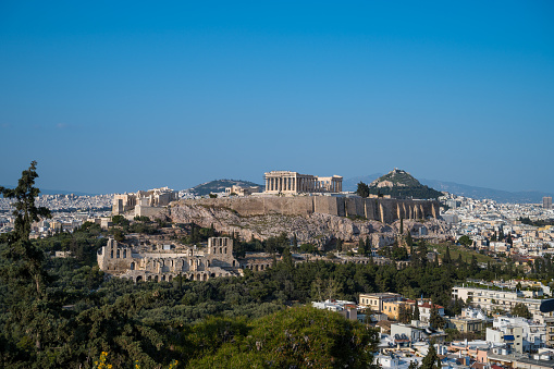Athens, Greece - April, 4, 2019:  View of Parthenon, Odeon of Herodes Atticus and the surrounding neighborhood in Athens