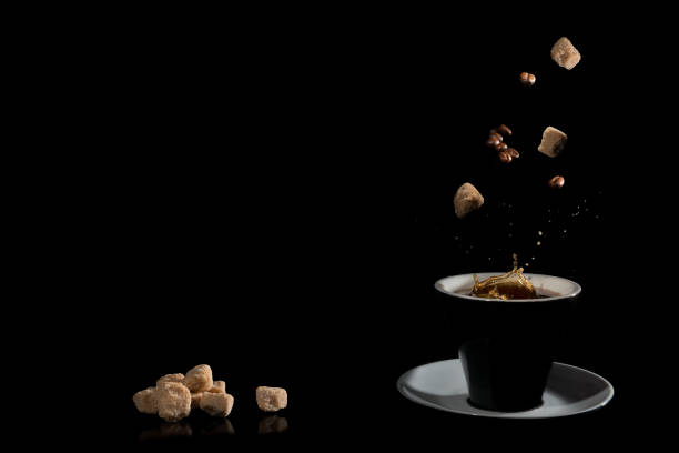 Coffee with coffee beans and cane sugar on a dark background.