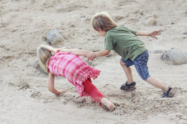istock Children help each other. Help concept outdoor 1145632915