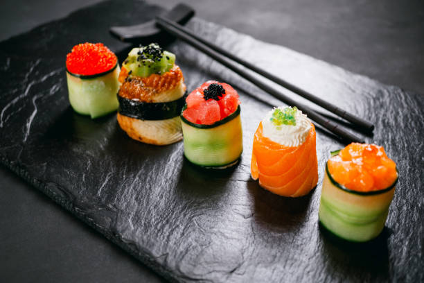 istock Seafood delicatessen sushi rolls on slate 1145633677