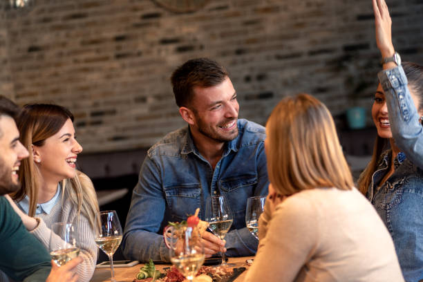 istock Group of young friends having fun in restaurant. 1145634819