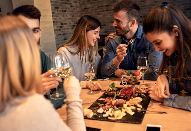 istock Group of young friends having fun in restaurant. 1145634820