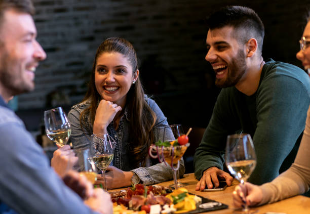 istock Group of young friends having fun in restaurant. 1145635016