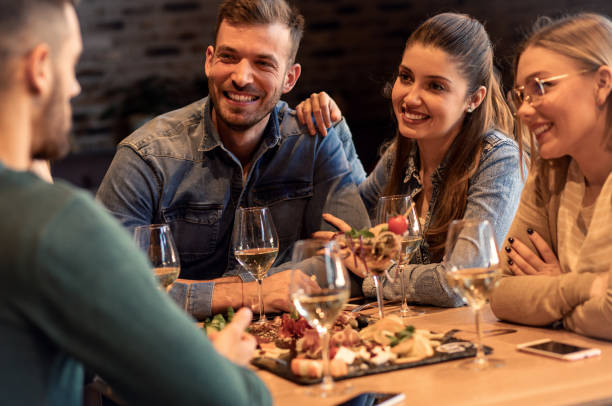 istock Group of young friends having fun in restaurant. 1145635162