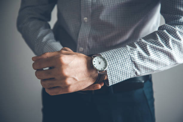 istock man hand watch on gray background 1145638031