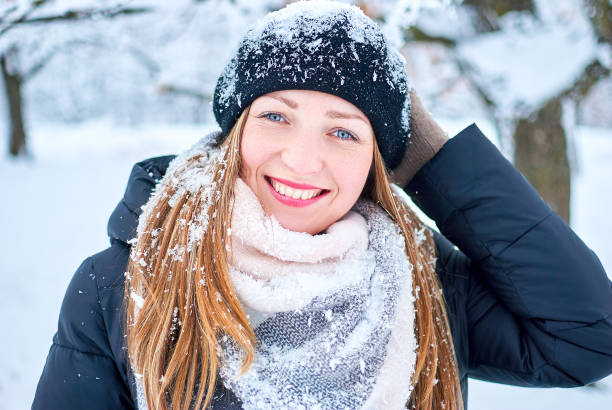 istock Beautiful Girl playing with snow in park 1145638129