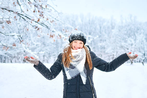 istock Beautiful Girl playing with snow in park 1145638157