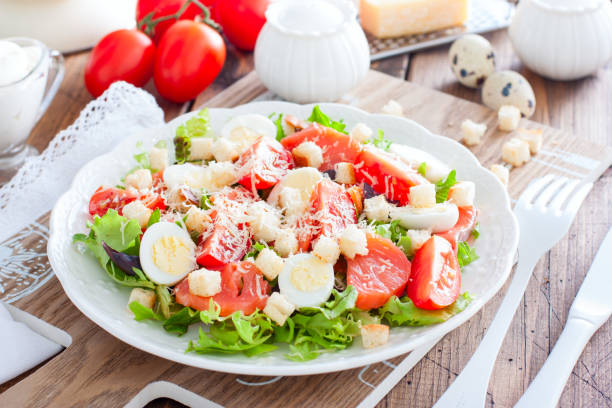 istock Caesar salad with red fish on the wooden table, horizontal 1145639076
