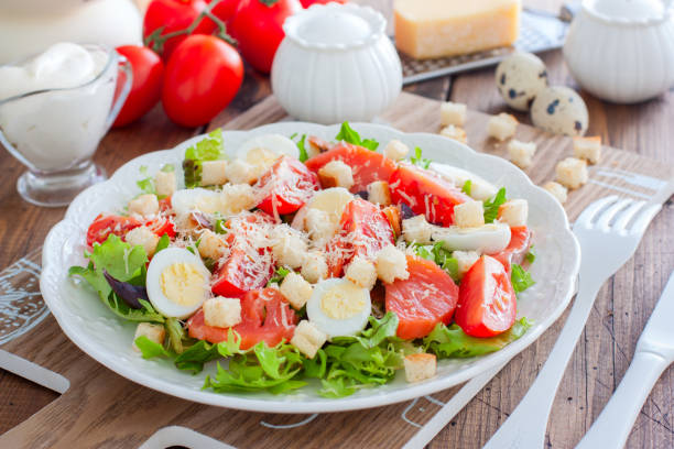 istock Caesar salad with red fish on the wooden table, horizontal 1145639145