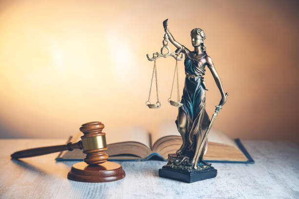 istock judge with justice lady and book on desk 1145639491