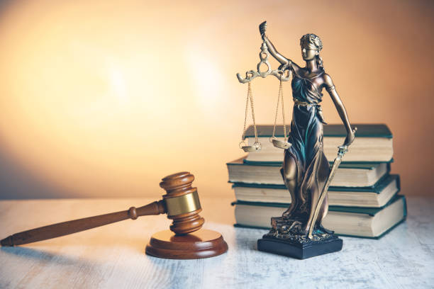 istock judge with justice lady and book on desk 1145639512