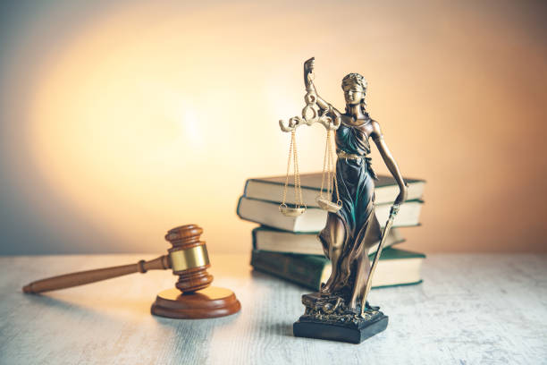istock judge with justice lady and book on desk 1145639542