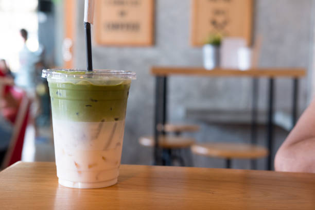 istock Matcha green tea iced latte on wood table 1145639782