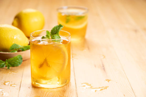 Hot lemon tea in the glass on white background.