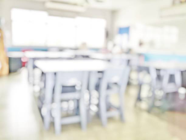 istock School classroom in blur background without young student; Blurry view of elementary class room no kid or teacher with chairs and tables in campus. 1145642392