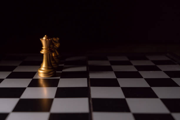 istock Close up shot chess on the board game with dark mood and tone process competition concept 1145642483