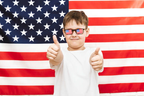 istock happy boy on american flag background 1145642859