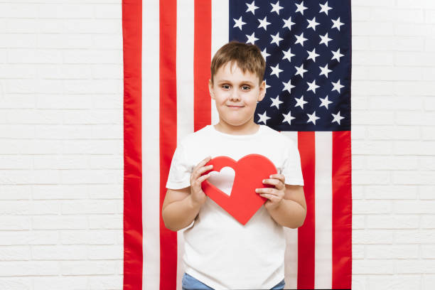 istock happy boy on american flag background 1145642860