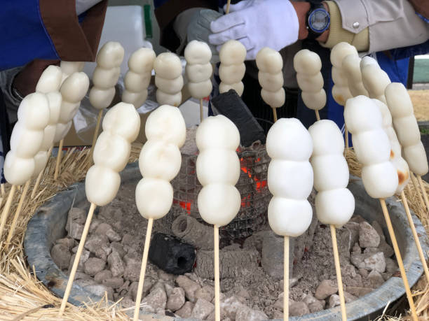 istock Mitarashi Dango stick grilled on fire, Japanese traditional sweet snack 1145644234