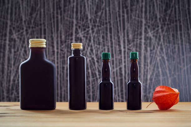 Four dark bottles and physalis