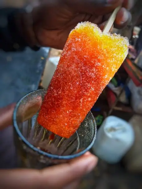 Photo of Famous Indian ice cream made up of only ice and made with lots of varietys. Most popularly known as chuski or Baraf ka Gola or ice candy in India