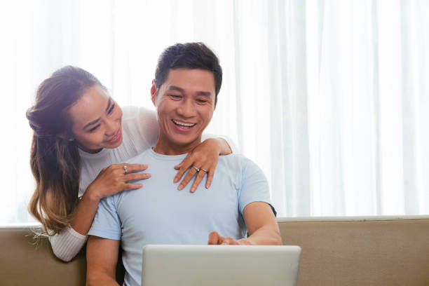 istock Couple drinking coffee and shopping online 1145647258