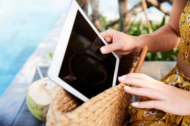 istock Woman taking device out of purse 1145647524