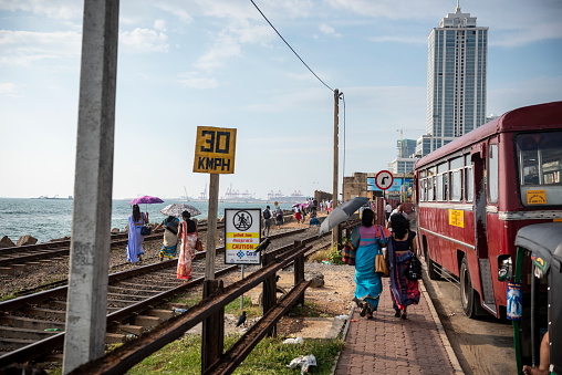 People walk along the train tracks leading to Kollupitiya Railway Station in Colombo, Sri Lanka. (March 30, 2017)