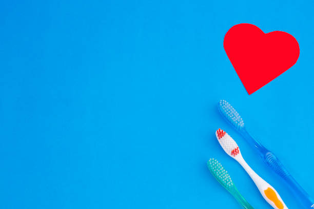 istock Toothbrush - Red heart. Blue background 1145651607