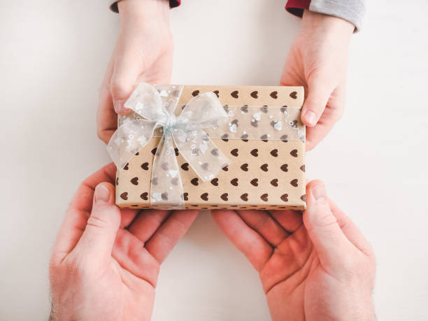 istock Child congratulates his Father. Beautiful gift box 1145652865
