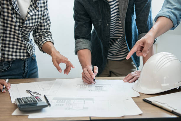 istock Engineer Teamwork Meeting, Drawing working on blueprint meeting for project working with partner on model building and engineering tools in working site, Construction and structure concept 1145655734