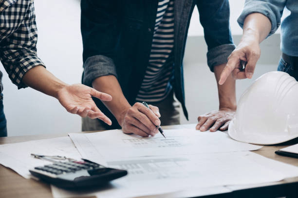 istock Construction and structure concept of Engineer or architect meeting for project working with partner and engineering tools on model building and blueprint in working site, contract for both companies 1145655739