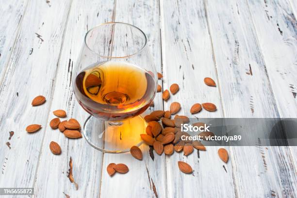 Strong Alcoholic Beverage Amaretto Liqueur In Sniffer Glass Stock Photo - Download Image Now