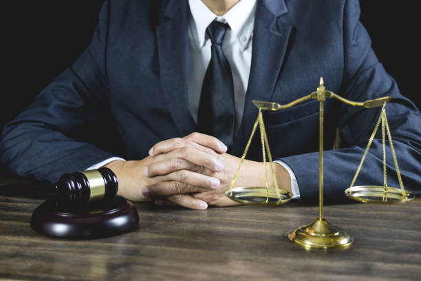 Counselor or Male lawyer working on courtroom sitting at the table. Legal law, Judge gavel with Justice lawyers advice with gavel and Scales of justice Counselor or Male lawyer working on courtroom sitting at the table. Legal law, Judge gavel with Justice lawyers advice with gavel and Scales of justice. wrongful conviction stock pictures, royalty-free photos & images