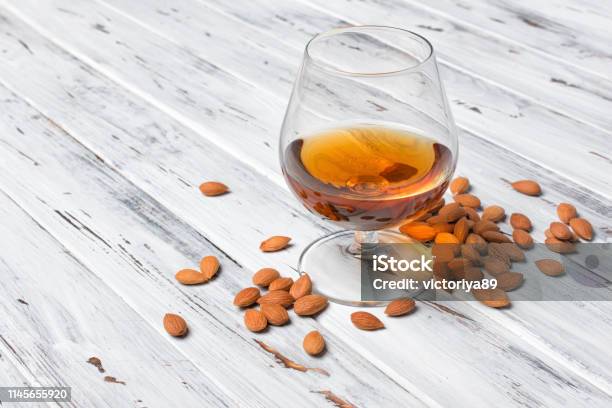 Strong Alcoholic Beverage Amaretto Liqueur In Sniffer Glass Stock Photo - Download Image Now
