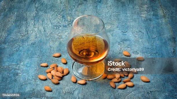 Strong Alcoholic Beverage Amaretto Liqueur In Sniffer Glass Stock Photo - Download Image Now