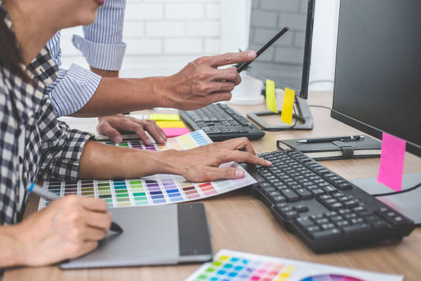 istock Young creative team having a meeting in creative office, Architectural drawing with work tools and accessories, Color swatch samples chart for selection coloring 1145655958