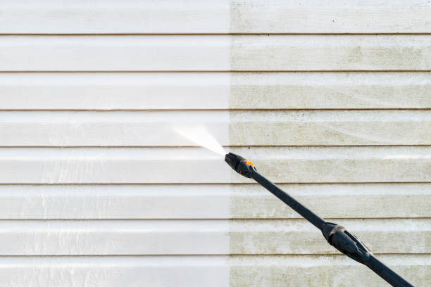 Cleaning service washing building facade with pressure water. Cleaning dirty wall with high pressure water jet. Power washing the wall. Cleaning the facade of the house. Before and after washing stock photo
