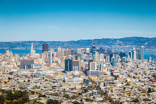 Beautiful panoramic view of San Francisco city skyline from Twin Peaks vista viewpoint on a scenic sunny day with blue sky, California, USA