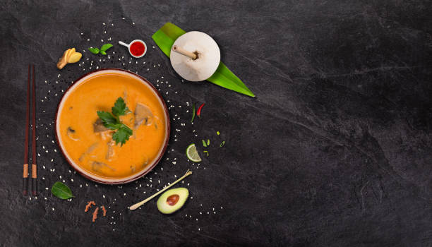 istock Yellow curry asian food background with various ingredients on stone table. 1145662147