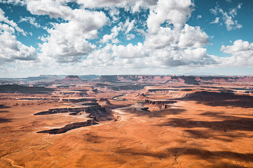 Scenic Green River overlook with dramatic clouds and blue sky on a sunny day in beautiful Canyonlands National Park, Utah, USA