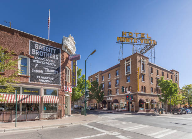 Historic city center of Flagstaff, Arizona, USA Beautiful view of the historic city center of Flagstaff with famous Hotel Monte Vista on sunny day with blue sky in summer, northern Arizona, American Southwest, USA route 66 sign old road stock pictures, royalty-free photos & images