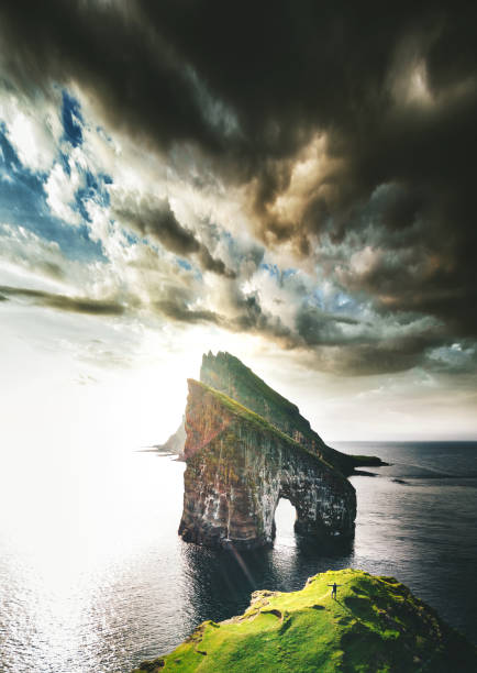 istock man with arm raisd camping at the faroe islands 1145669372