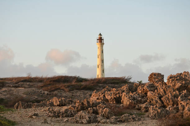 California lighthouse in Aruba with a volcanic rocks.