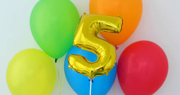 istock Gold foil number 5 celebration balloon on a color 1145675352