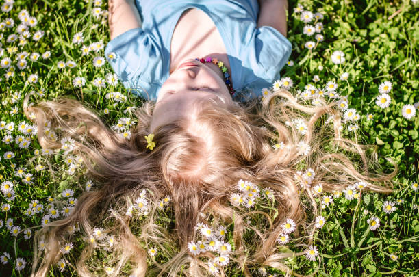 istock cute child lying in daisy meadow 1145675749