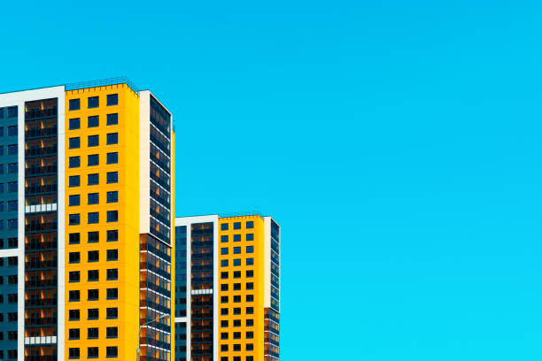 Lisbon, Portugal - May 05, 2008: Colorful yellow modern facade of apartment building with multiple windows and balconies in Lisbon, Portugal on May 05, 2008.